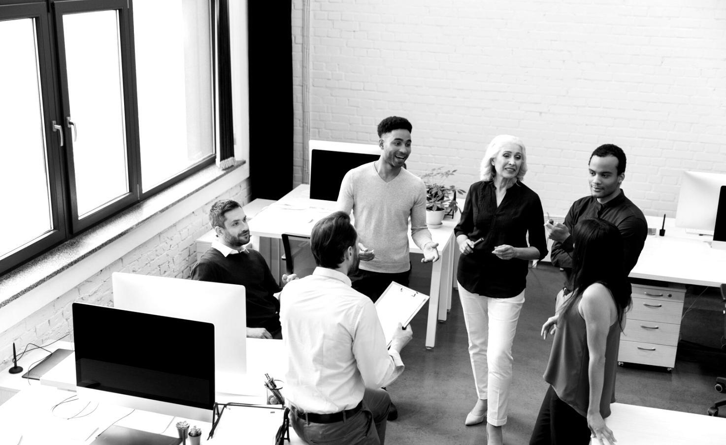 Modern office meeting room with financial charts displayed on screens